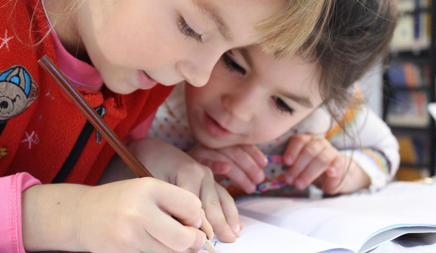 Two children helping eachother
