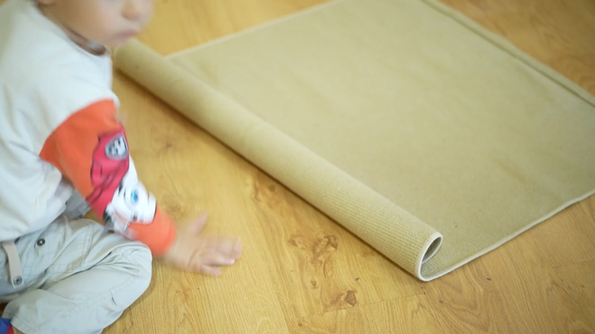 Montessori Student using a work rug